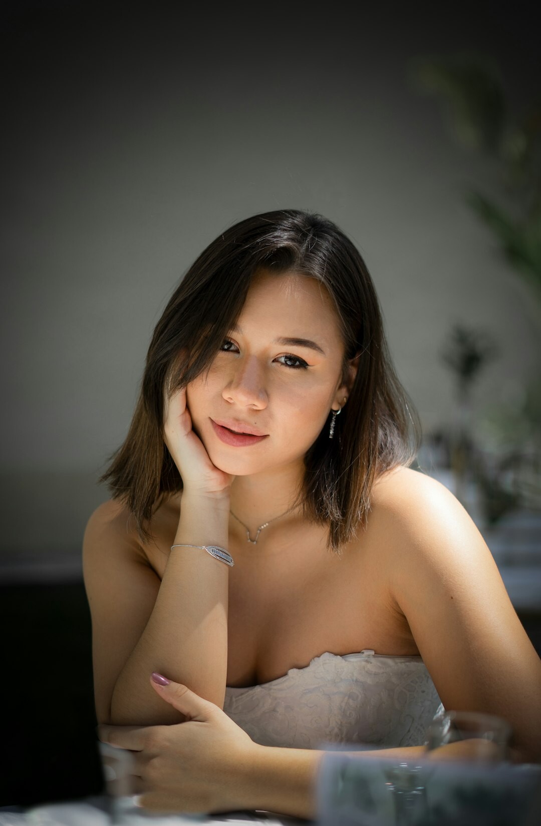 Studio portrait of a young Asian woman developer smiling