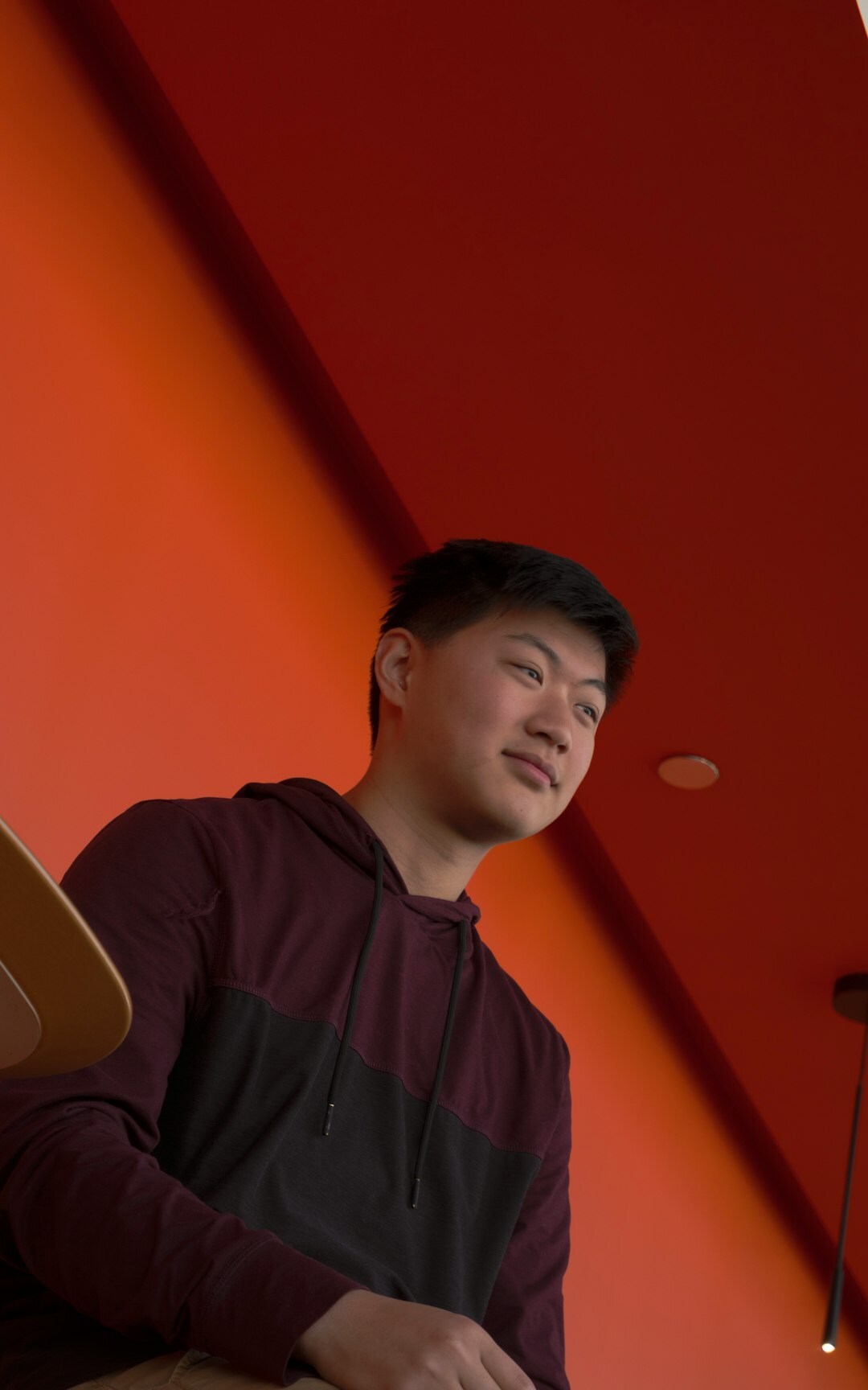 Studio portrait of a young Asian man developer with a friendly smile