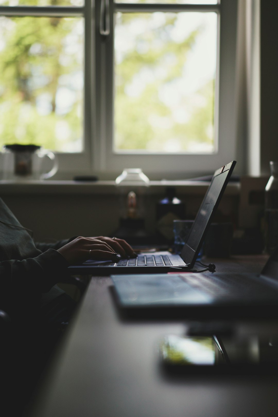 person coding on laptop at home