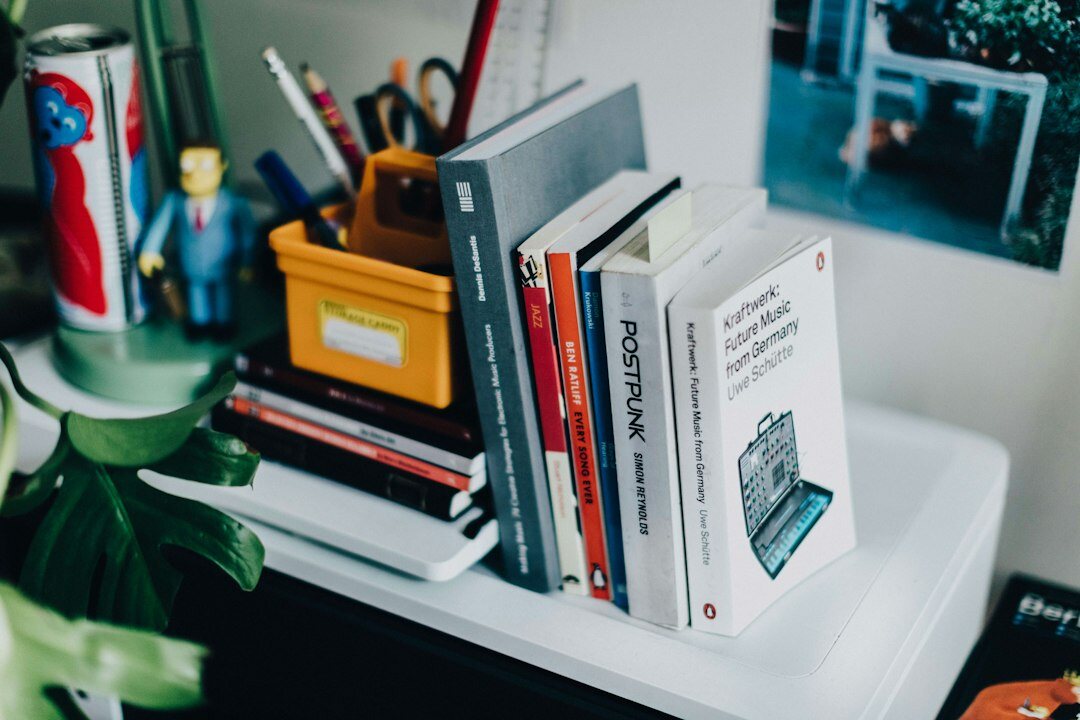 woman coding at desk with books