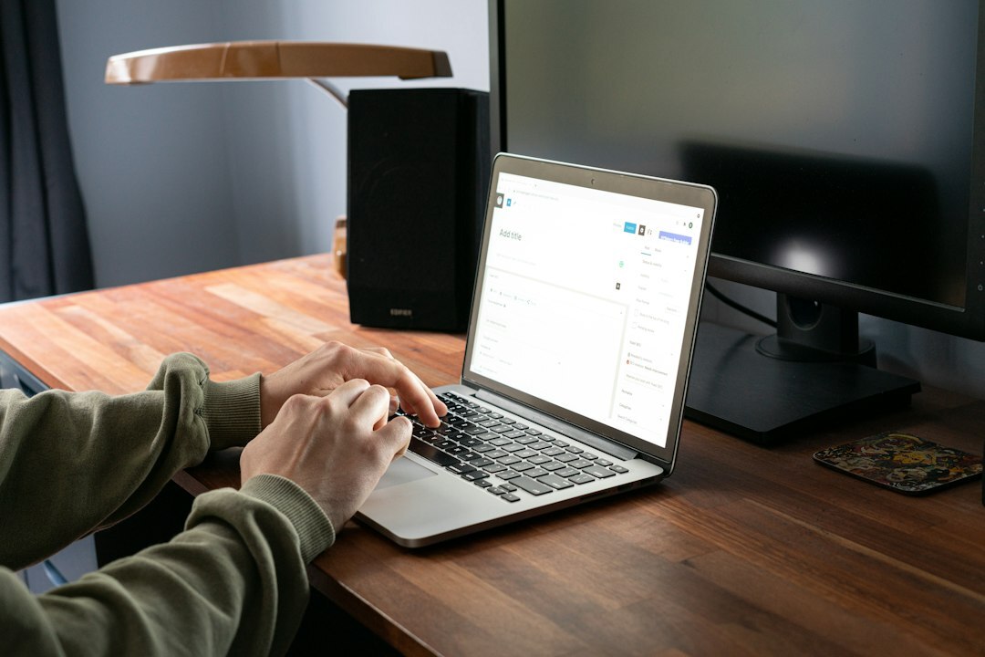 person coding on laptop at desk