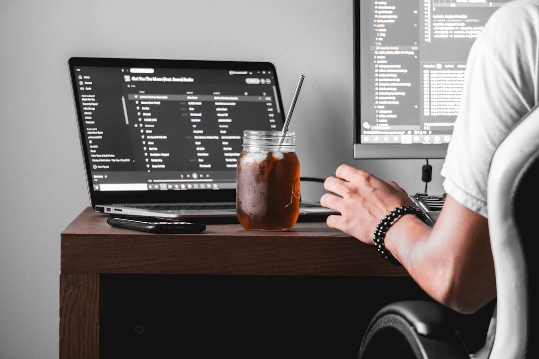 person coding on laptop at desk