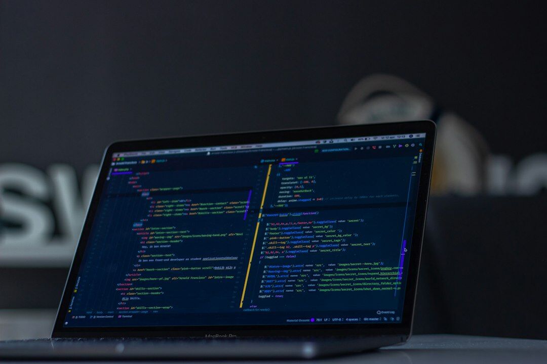 programmer coding on laptop